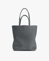 Tote bag with two handles on plain background.