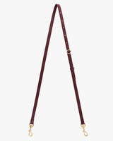 Long adjustable leather strap with clasps at both ends.