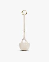 Small textured pouch with strap and circular metal ring at the top.