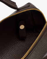Open travel bag with zipper and button strap inside