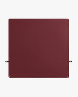 Square mat with small gold corner accents and two side straps.