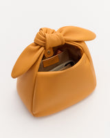 Bag with handle, open to show interior and small items inside.