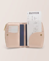 Open wallet holding cards and a boarding pass