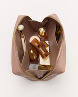 Open makeup bag with various cosmetics and tools inside