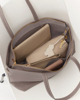 Open travel bag with wallet, pouches, and key inside.