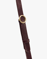 Leather strap with croc-embossed pattern and gold buckle.