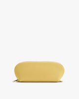 Oval-shaped zippered pouch on plain background.