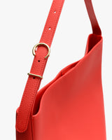 Shoulder bag with adjustable strap and gold buckle.