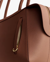 Handbag with a zipper and handles.