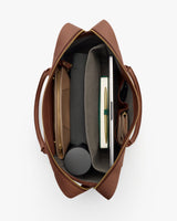 Top view of an open travel bag with various items inside.