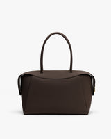 Handbag with curved handles and rectangular body on a plain background.