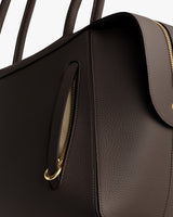 Close-up of handbag with zipper and handles.