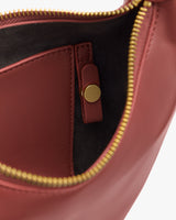 Open view of a bag showing inner pocket and zipper.