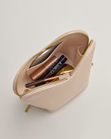 Open makeup bag with various cosmetics inside.