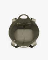 Open handbag with pockets and handles viewed from above.