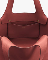 Open handbag with visible inner pocket and button closures.