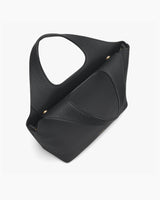 A slouchy handbag with a broad handle and textured surface.