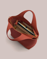 Open handbag with notebooks and pens inside