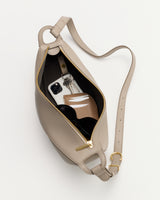 Open bag with phone, wallet, sunglasses, and keys inside.