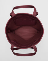 Open tote bag with handles and pocket inside.