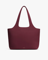 Large tote bag with shoulder straps on plain background