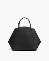 Geometric-shaped handbag with round handles.