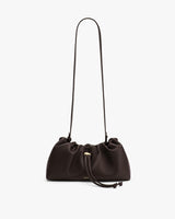 A handbag with a long strap and gathered top design.