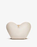 Heart-shaped purse with zipper standing upright