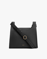 Handbag with shoulder strap and metal ring detail on front.