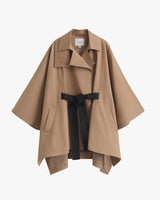 Trench coat with wide collar, belt, and flap pockets displayed against a plain background.