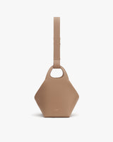 Handbag with a geometric shape and a wide strap