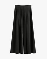 Wide-leg pants with pleats on a plain background.