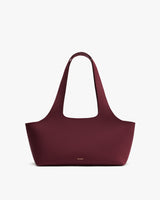 Handbag with long straps and minimal design on white background
