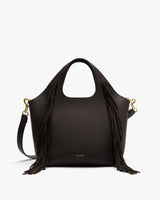 Handbag with fringes and a detachable strap.