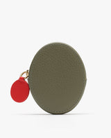 Oval-shaped coin purse with a small round tag attached.