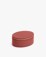 Oval-shaped zippered case with textured surface.