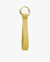 Keychain with a round metal ring and a textured strap.