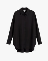 Button-up shirt displayed on plain background.