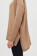 Close-up of a person wearing a long-sleeved top and pants.