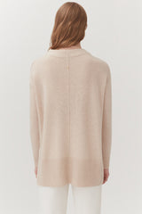 Person seen from behind wearing a long-sleeved top and pants.