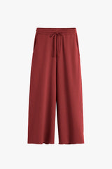 Wide-leg pants with drawstring waist, displayed on plain background.