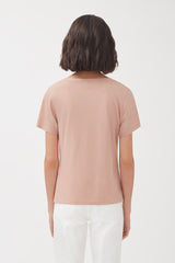 Person seen from the back wearing a T-shirt and pants.