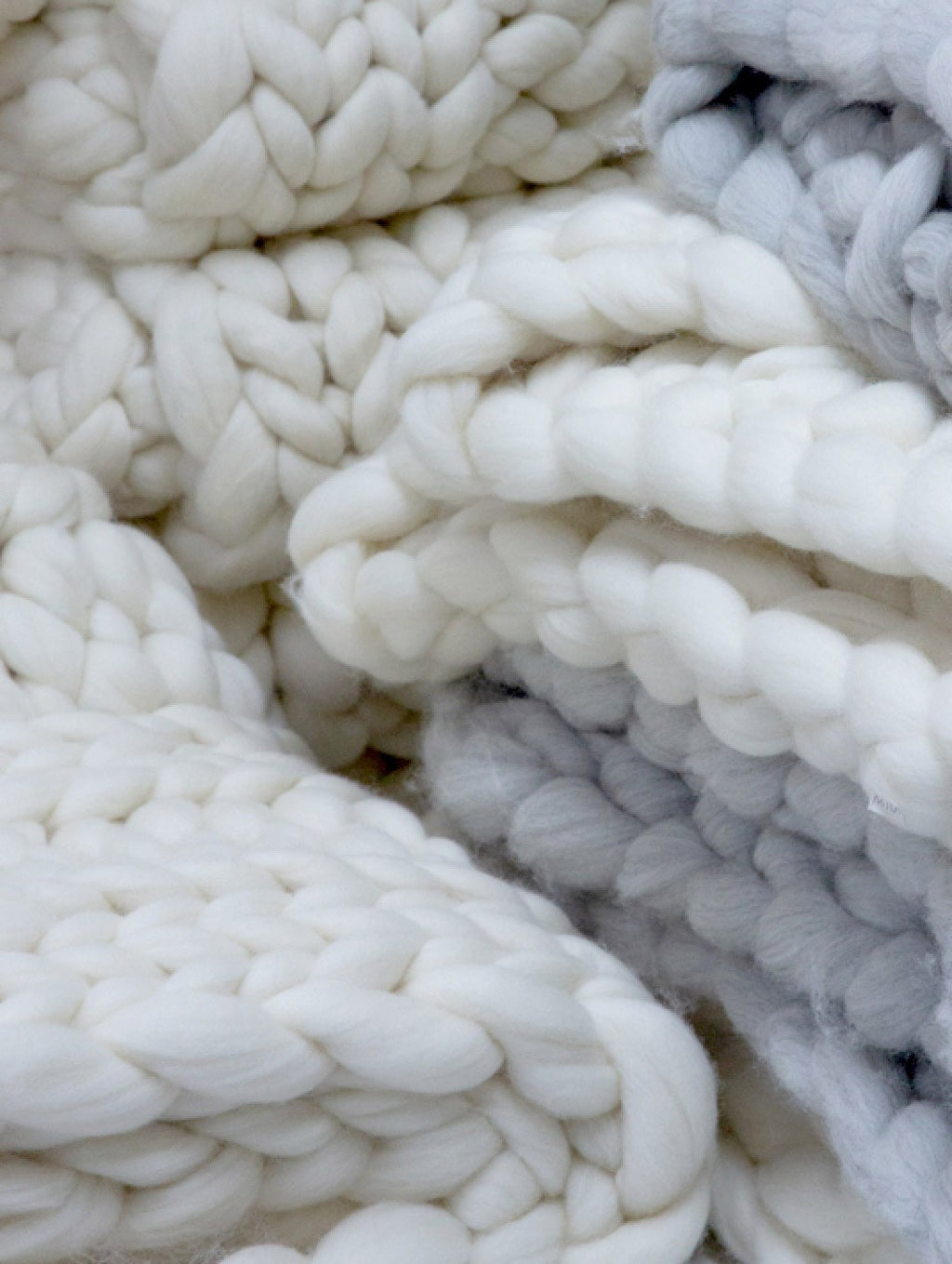 Close-up of thick woven fabric with large stitches.