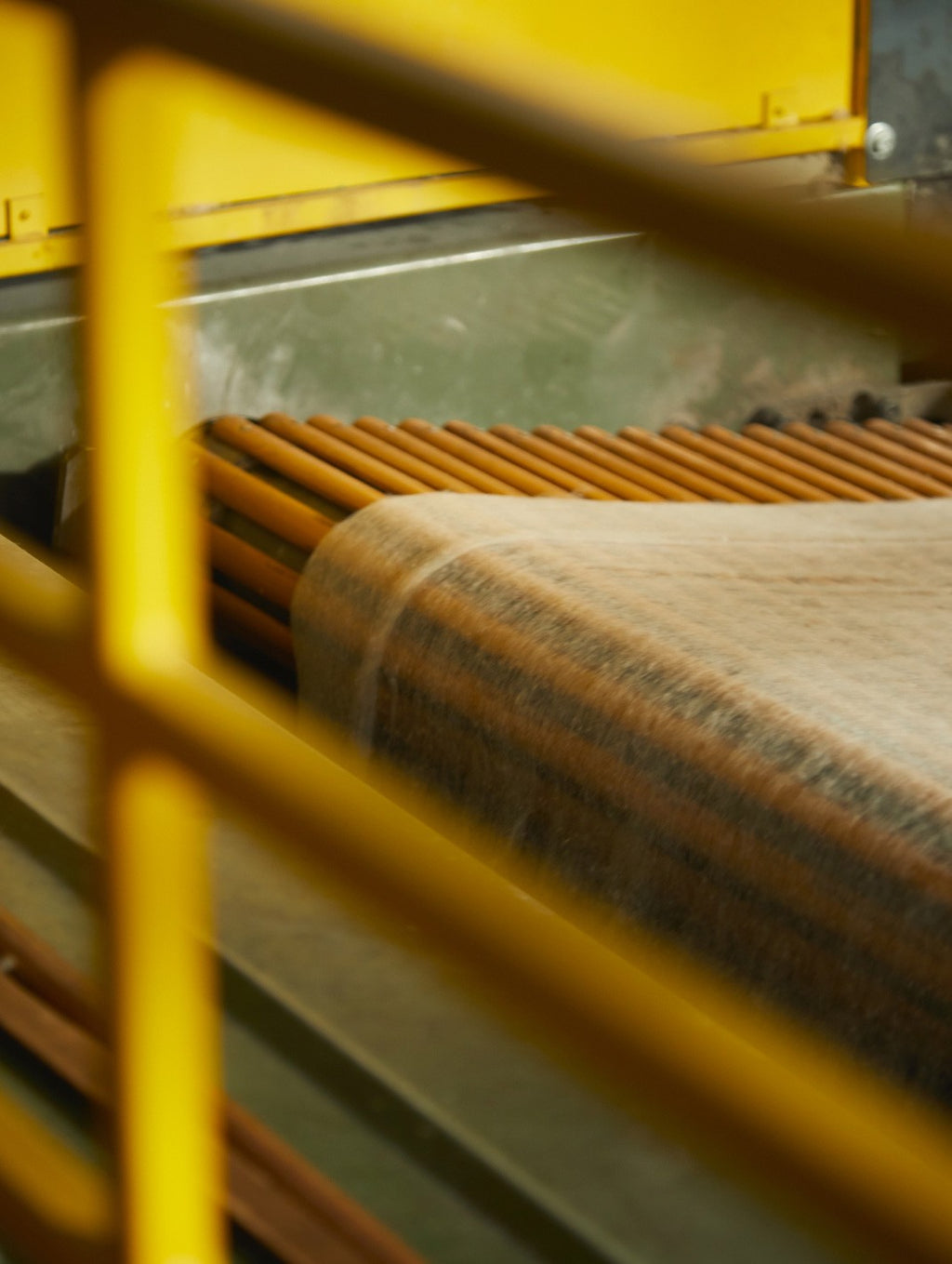 View of machinery parts through a metal grid.