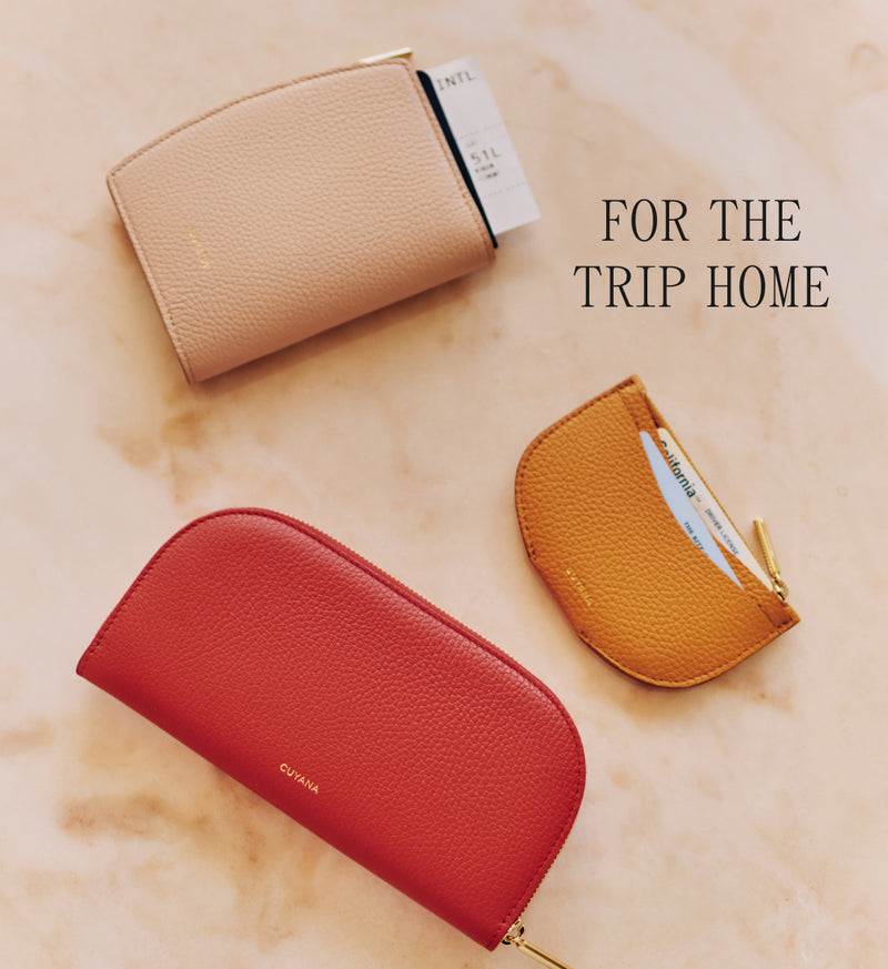 Three small leather pouches placed on a marble surface.