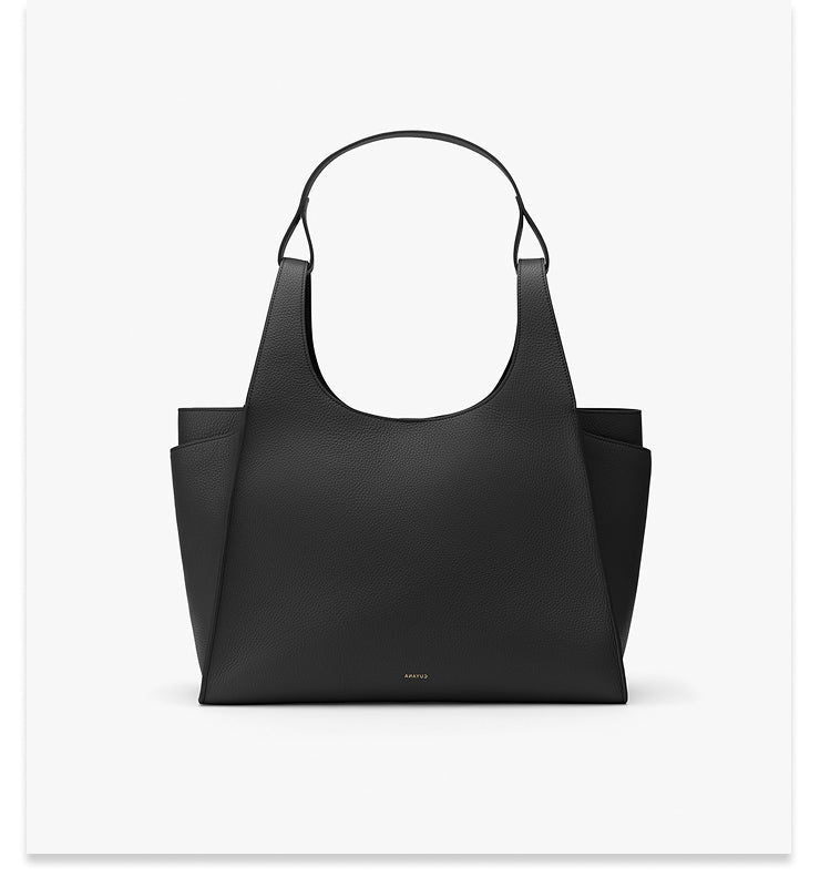 Handbag with two handles and side pockets displayed on a plain background.