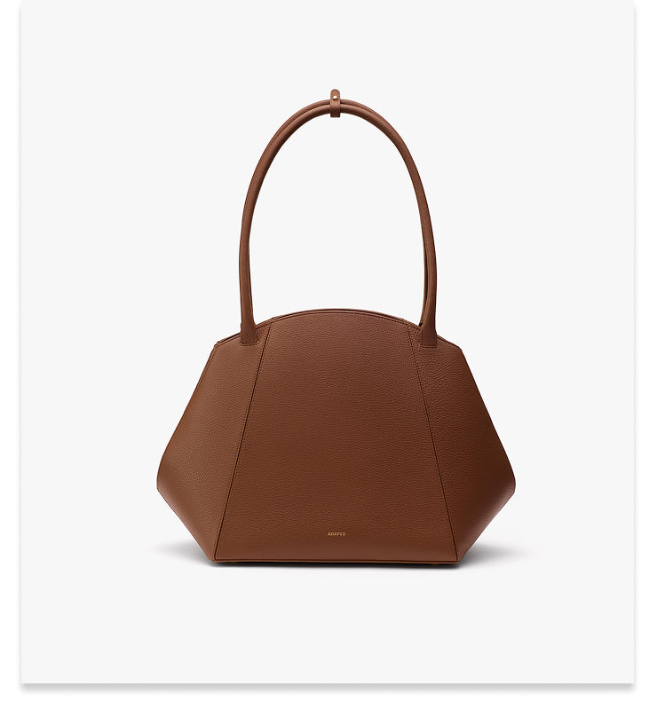 Handbag with a geometric shape and two handles.