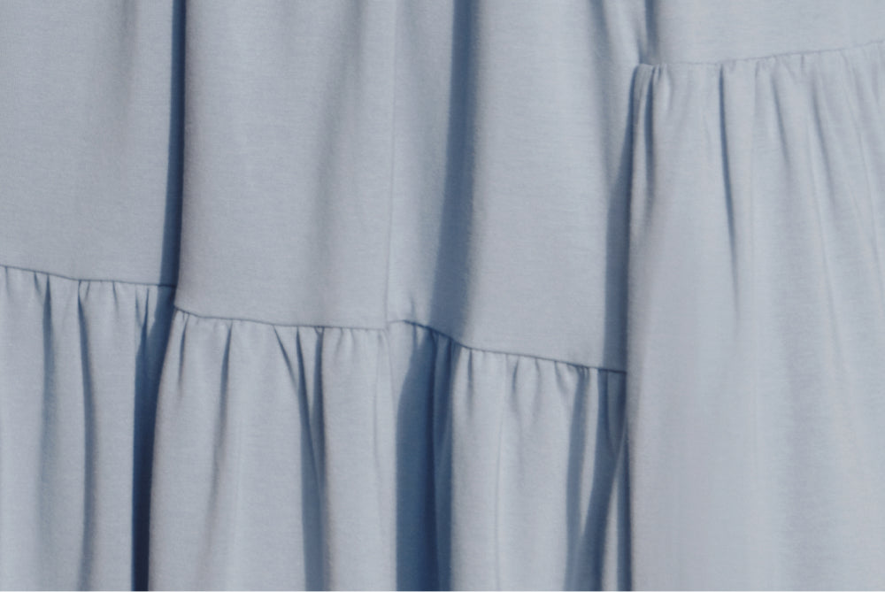 Close-up view of a garment with tiered ruffled design.