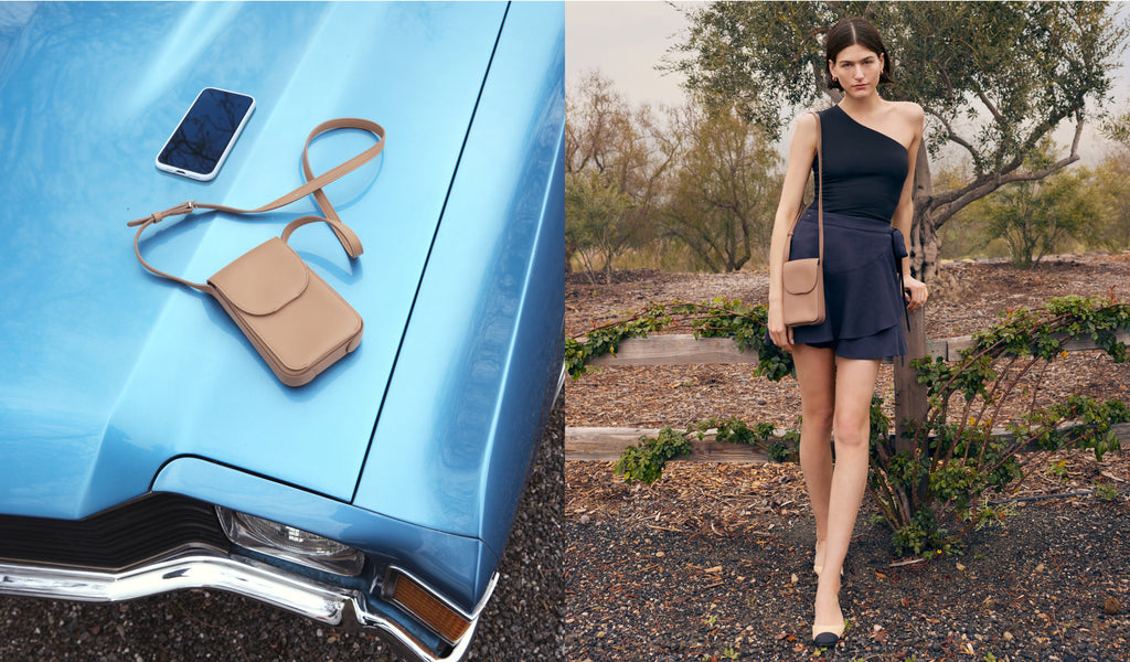 Phone and bag on car hood; woman standing by plants.