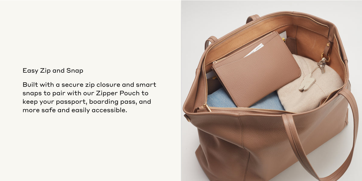 Open handbag with various items and a small pouch inside.